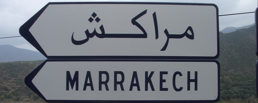 Road sign to Marrakech in Arabic and French