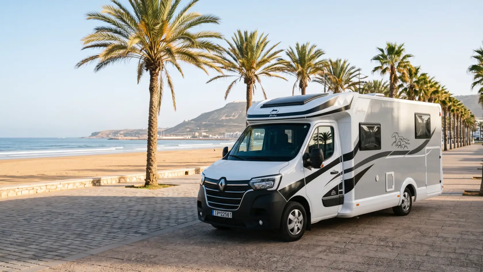 Agadir Adventurer 4-person Renault camper parked on the palm-lined beach promenade of Agadir, Morocco