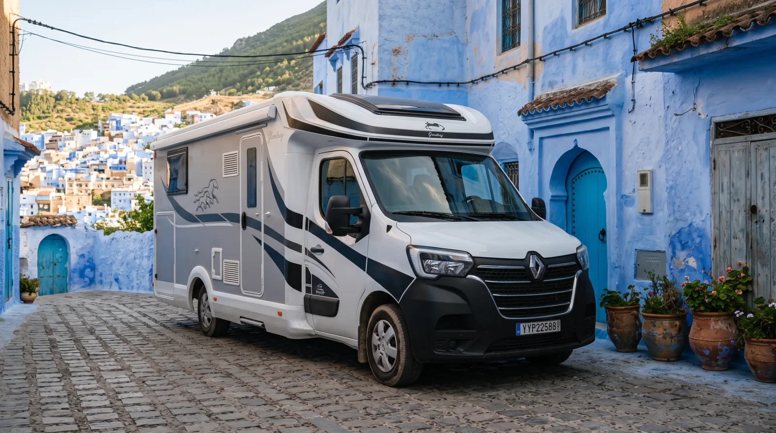 Riad on Wheels camper parked beside blue-painted walls outside the Chefchaouen medina in northern Morocco